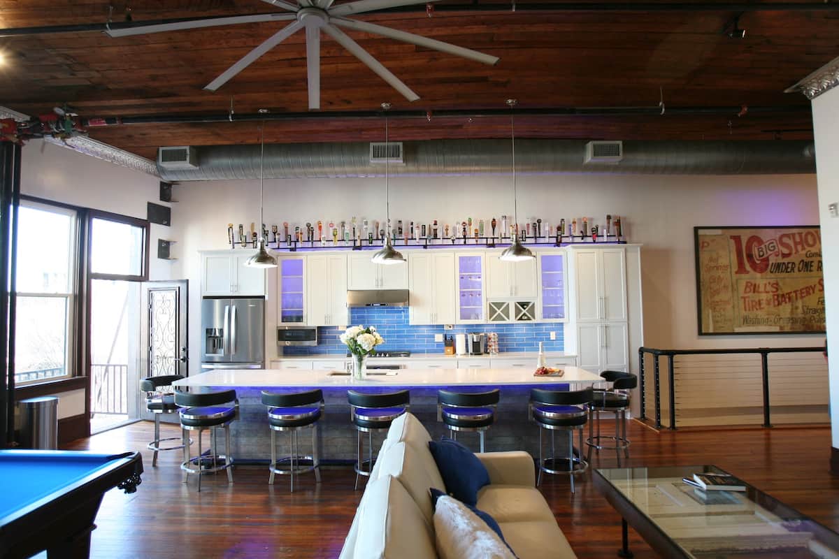 Open loft with kitchen island, seating and pool table